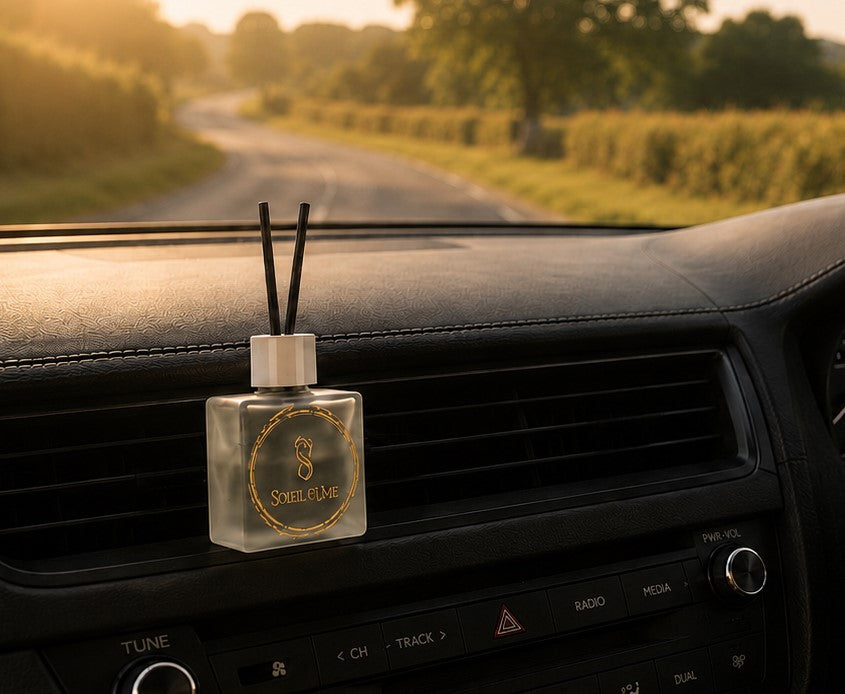 Soleil Fume luxury car diffuser displayed on a car dashboard with a countryside view.